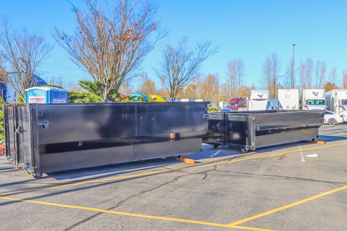 Professional dumpster rental service with roll-off container on residential driveway in Mount Laurel